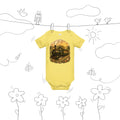 Vintage baby bodysuit showing steam train carrying swaddled babies with stork conductor, golden pastoral railway scene